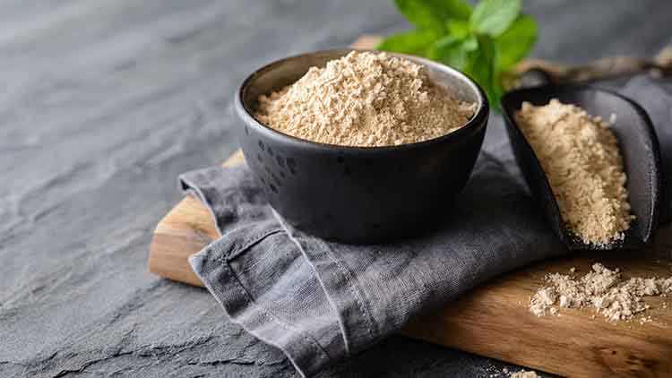 Dietary supplement, Maca root powder in a bowl and scoop